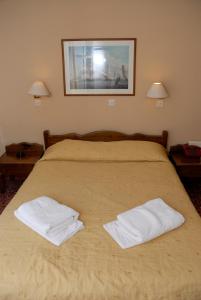 Katil atau katil-katil dalam bilik di Amaryllis Hotel