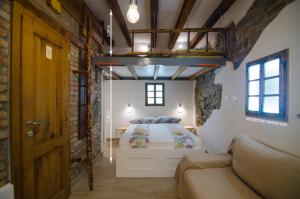 a bedroom with a bed and a couch in a room at Traditional Piran studio in Piran +36 photos