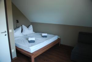 a bed with white sheets and pillows in a room at Ferienwohnung Sommeregger in Leutschach