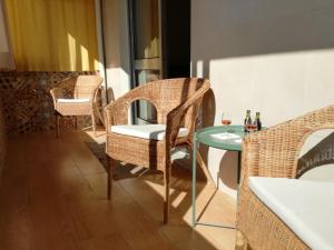 a room with a table and chairs and a table and a glass at A Casa da Maria in Porto