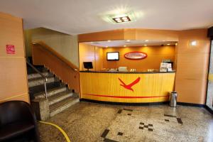 a lobby of a hotel with a counter and stairs at Hotel Vermont Ipanema in Rio de Janeiro