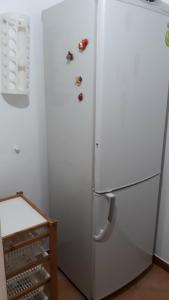 - un réfrigérateur blanc avec quelques chaussures sur la porte dans l'établissement Casa vacanze Filomena, à Marina di Camerota