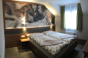 A bed or beds in a room at Hotel U koně
