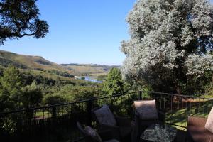 a view from the balcony of a house with chairs at Birdsong Cottages in Champagne Valley