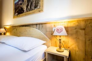 Posteľ alebo postele v izbe v ubytovaní Laurino Apartment