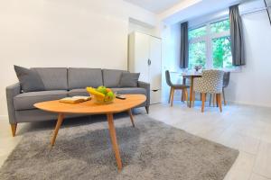 a living room with a couch and a table at Apartments Valentina free parking in Mostar