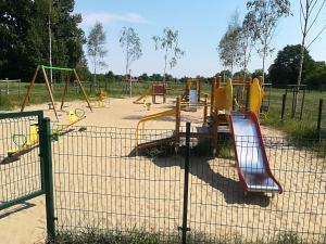 a playground with a bunch of slides and swings at Sopocka Oaza in Sopot