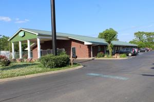 a red brick building with a green roof and a street at Apple Annie's Inn in Nashville