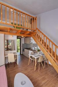 a kitchen and dining room with a staircase in a house at Smaragda Studios Skopelos in Skopelos Town