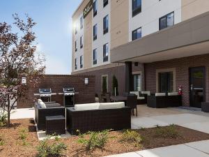 a patio with tables and chairs in front of a building at Extended Stay America Suites - Rock Hill in Rock Hill