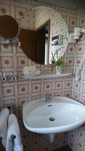 a bathroom with a white sink and a mirror at Café Blaich - Hotel Garni in Höfen an der Enz