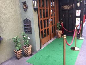 a front door of a building with a green floor at Café Blaich - Hotel Garni in Höfen an der Enz