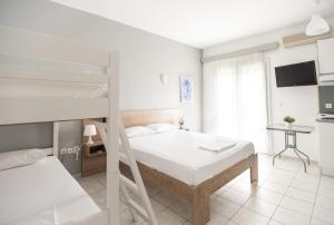 Postel nebo postele na pokoji v ubytování Afkos Apartments
