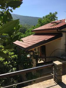 a house with a red tile roof with a view at Apartments Šmit in Cres