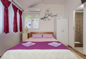 a bedroom with a large bed with two towels on it at Apartment Panorama in Kotor +37 photos
