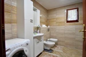 a bathroom with a washing machine and a toilet at Keep calm in Sarajevo