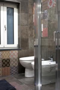 a bathroom with a toilet and a sink at Pompei TERAFI Home in Pompei