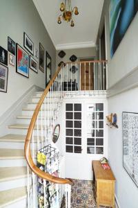 a spiral staircase in a home with white walls at Au Petit Bonheur in Talence