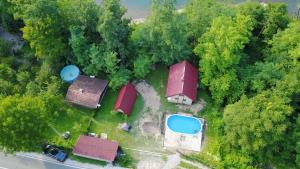 an overhead view of a farm with houses and a pond at Alaske kolibe in Bajina Bašta +28 photos