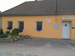 a yellow house with a white door and windows at Ubytování GM in Znojmo +7 photos