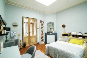 a bedroom with a bed and a table and chairs at Au Petit Bonheur in Talence