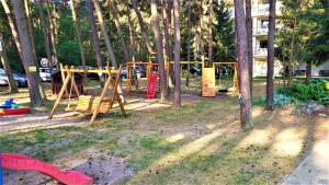 a park with a playground with trees and a play set at Apartament El Sol in Łukęcin