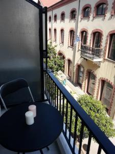 a table on a balcony with a view of a building at Kalliopi's Guesthouse in Kavala