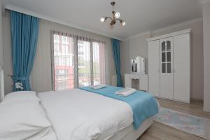 a bedroom with a bed and a large window at North Pearl Residence in Trabzon