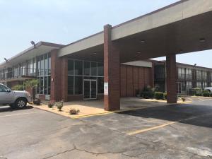 an empty parking lot in front of a building at Mid Continent Inn in Greenwood