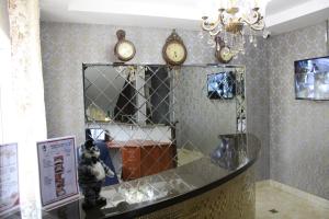 a shop with clocks on the wall and a counter at Кот in Kurgan