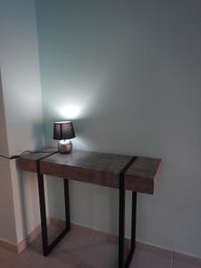 a table with a lamp on it in a room at Modern sea view appartment in Artemida