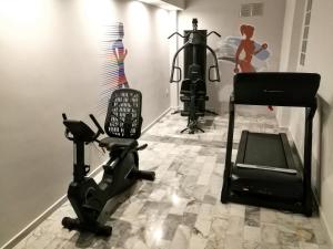 a room with a gym with a treadmill and a camera at Erato Hotel in Agia Marina Aegina