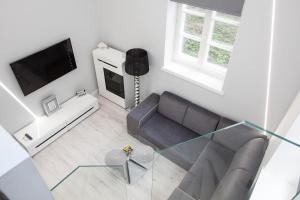 a living room with a couch and a tv at Apartament MnW in Warsaw