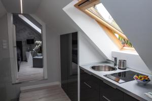 a kitchen with a sink and a window at Apartament MnW in Warsaw