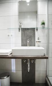 a bathroom with a white sink on a counter at Altstadt Ferienwohnung An Der Stadtmauer in Füssen