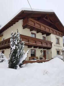 a building with snow in front of it at Haus Wiesenheim FW Ötztal in Längenfeld