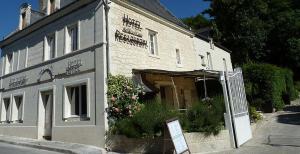 a white brick building with a sign in front of it at Le Clos d'Ussé in Rigny-Ussé