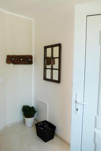 a room with a mirror and a plant on a wall at Happy River House in Kamna Gorica +20 photos