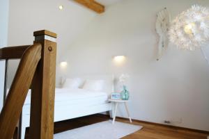a bedroom with a bed and a table with a chandelier at Happy River House in Kamna Gorica