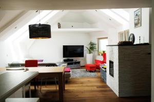 a living room with a table and a fireplace at Happy River House in Kamna Gorica