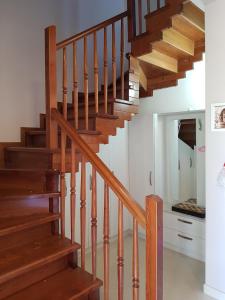 a staircase in a house with wooden steps at Villa "GREEN PARADISE" in Divjakë