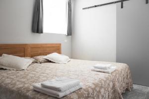 Łóżko lub łóżka w pokoju w obiekcie Pension Casa Maruja