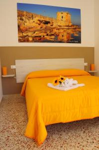 A bed or beds in a room at Le Sette Meraviglie