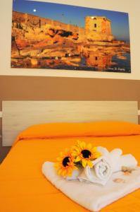 A bed or beds in a room at Le Sette Meraviglie