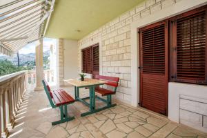 a patio with a table and chairs on a balcony at Apartment Ante in Omiš