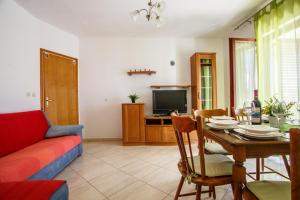 a living room with a table and a couch at Apartment Ante in Omiš