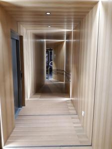 a hallway of a building with wooden walls and a mirror at Apartamento Pamplona 1 in Pamplona