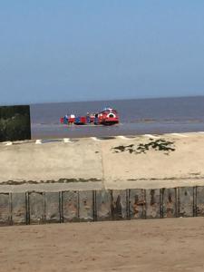 two emergency vehicles on a beach near the ocean at Pine drive in Mablethorpe