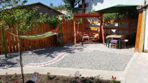 a backyard with a hammock and a fence at Casa Stefania in Eforie Nord