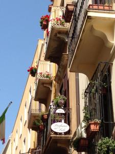 a building with balconies and a sign on the side of it at Il Profumo del Sale in Marsala